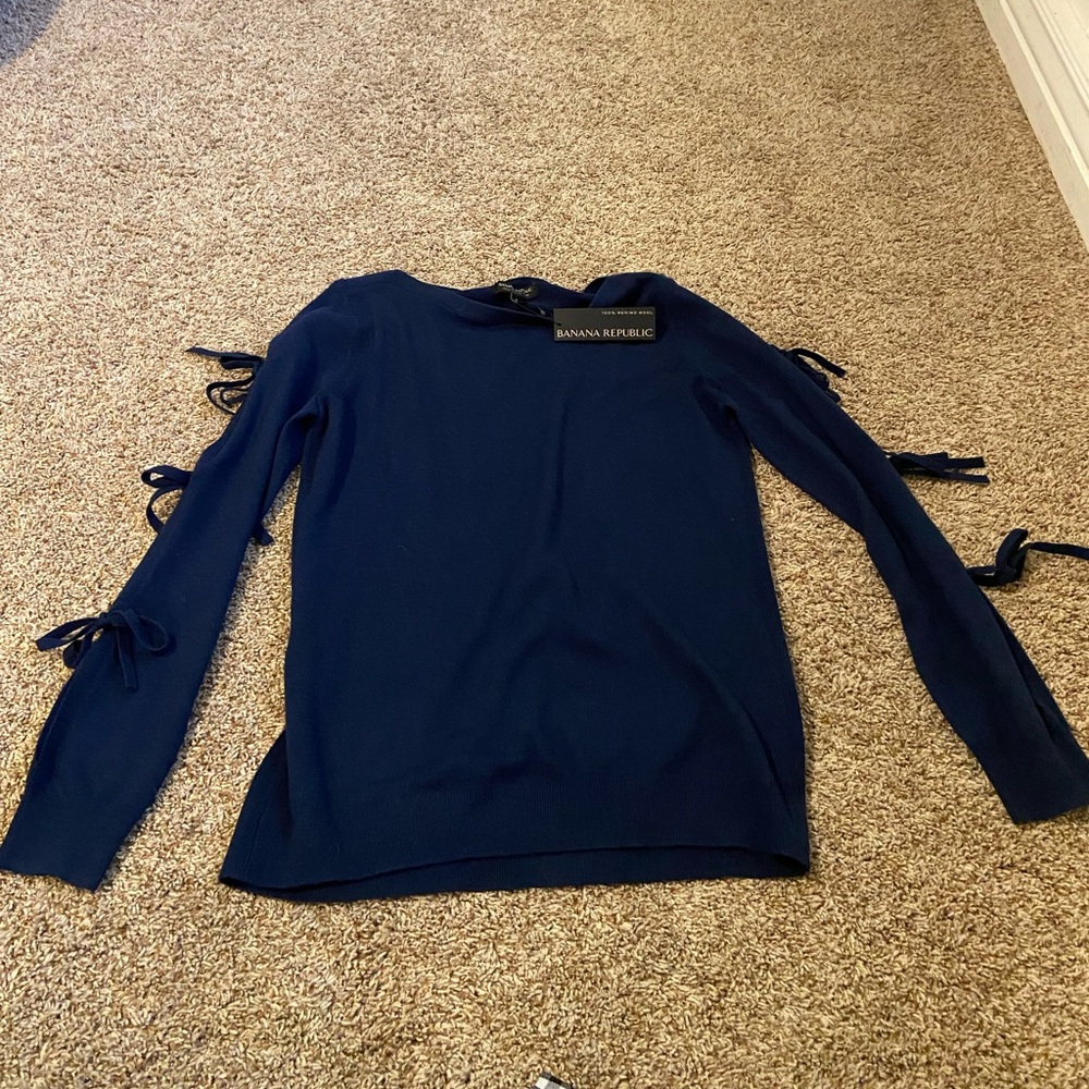 Banana Republic navy blue sweater with ties on the sleeve.